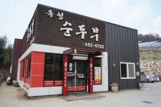옥성순두부 외관 — 간판, 빨간 문틀, 앞마당 주차장